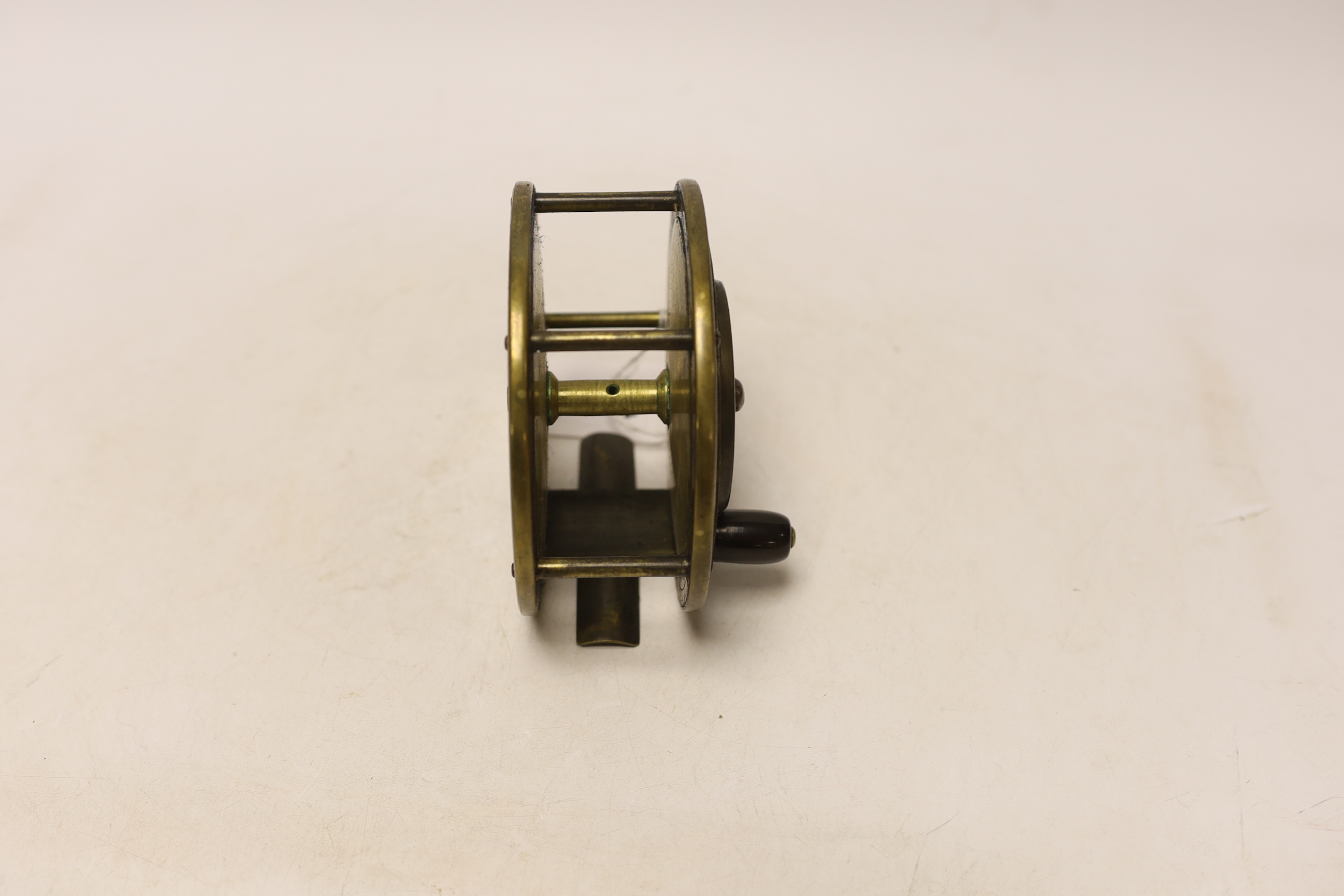 A large Bernard & Sons leather cased fishing reel